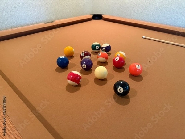 Obraz Billiards Table 9-Ball Game: Pool table with beige felt cloth featuring multiple balls arranged for a game.