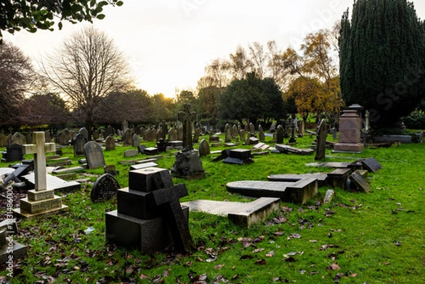 Fototapeta Overturned and fallen gravestones in an old cemetery