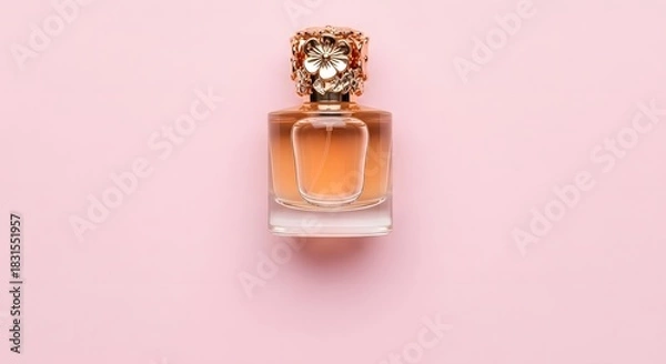 Fototapeta Elegant perfume bottle with ornate gold cap on soft pink background