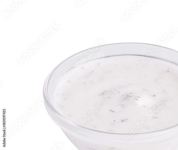 Fototapeta Creamy white dip with herbs in a glass bowl on a plain background
