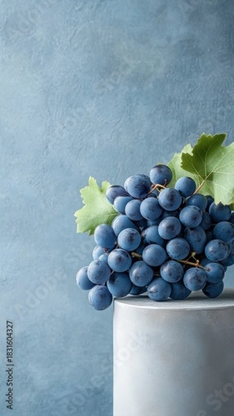 Fototapeta Grapes displayed on an elegant podium, showcasing their rich purple hue and delicate texture.