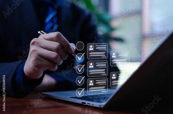 Fototapeta A business professional is working on a computer using a business performance appraisal on a laptop, completing an online survey and a digital form checklist, which showcases HR technology.