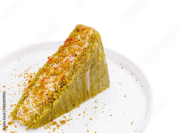 Fototapeta Delicious slice of pistachio cake with saffron on a clean plate