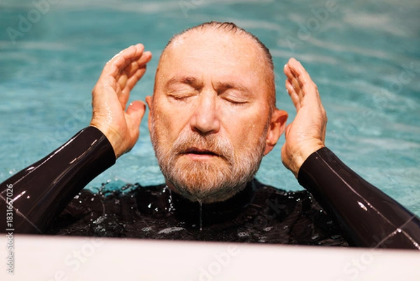 Fototapeta Senior diver in wetsuit preparing to dive in swimming pool