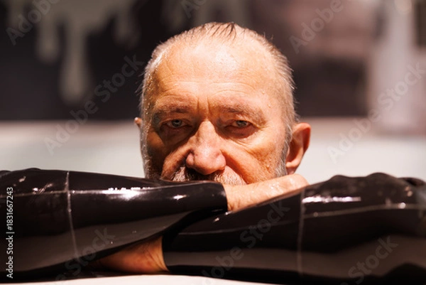 Fototapeta Grey haired free diver in wet suit looking at camera in swimming pool 