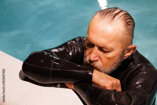 Fototapeta High angle view of free diver resting at poolside 