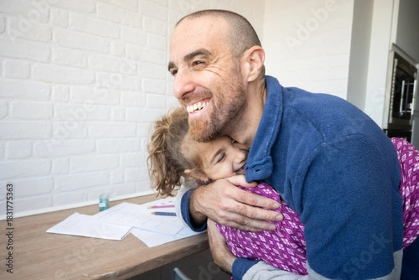 Obraz Father hugging his daughter after finishing school homework