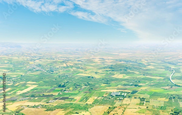 Fototapeta panoramic view from high mountain to a beautiful landscape with valley and fields of great lands far away.