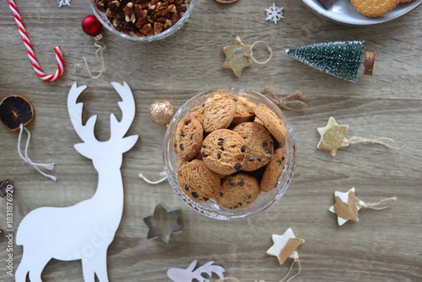 Fototapeta Various Christmas decorations, cookies, chocolate and nuts on wooden background. Flat lay.