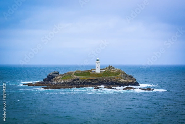 Fototapeta View over the lighthouse in Cornwall with blue sky 