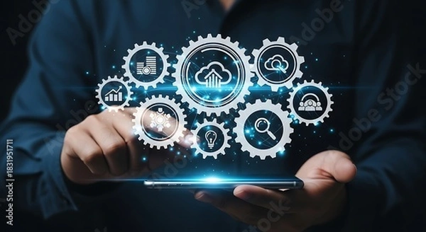 Fototapeta Man using a smartphone with holographic gears displaying cloud computing and data analytics concepts for business and technology solutions in the digital age