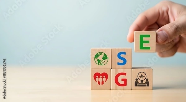 Fototapeta Building blocks of esg hand placing e on stack representing environmental social and governance factors for sustainable investment
