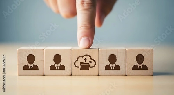 Fototapeta Human resources and cloud computing concept finger pointing at wooden blocks with people icons representing team and technology integration