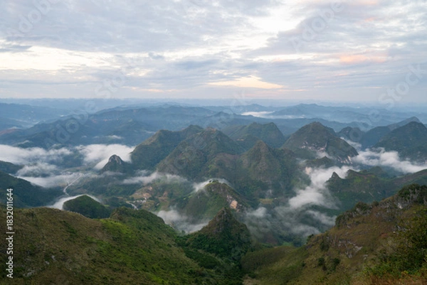 Fototapeta Sea of Clouds Floating Between Karst Mountain Peaks at Dawn in Guangxi China