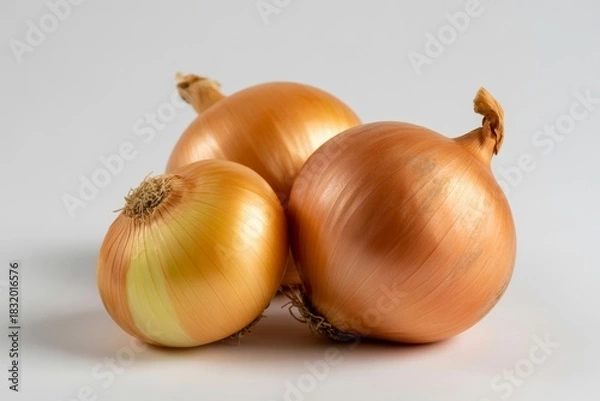 Fototapeta Three golden onions isolated on white background