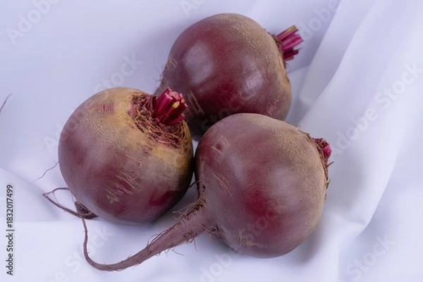 Fototapeta Three fresh beetroot vegetables isolated on white background