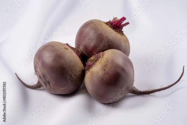 Fototapeta Three fresh beetroots with green tops isolated on white background