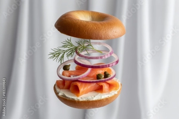 Fototapeta Smoked salmon bagel with cream cheese and red onion isolated on white background