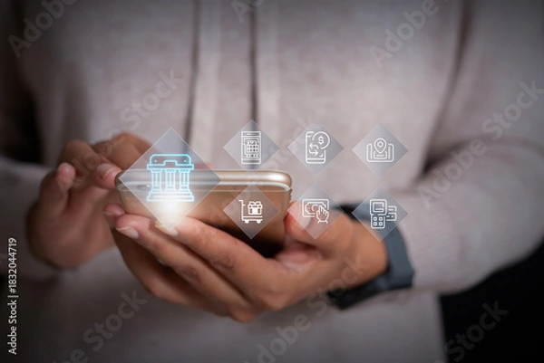 Fototapeta Hands holding smartphone with digital banking and online payment icons, representing mobile finance, e-commerce, and fintech services.