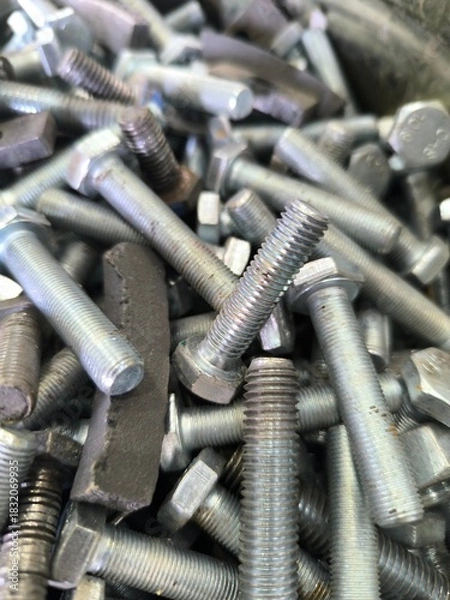 Fototapeta close-up of scattered bolts. Production Concept