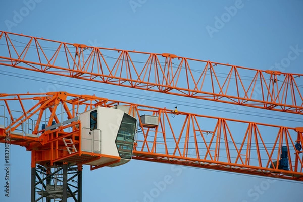 Fototapeta crossing cranes on the construction site