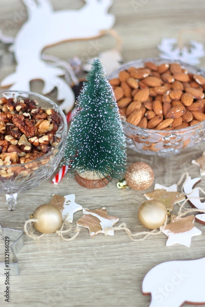 Fototapeta Various Christmas decorations, cookies, chocolate and nuts on wooden background. Selective focus.