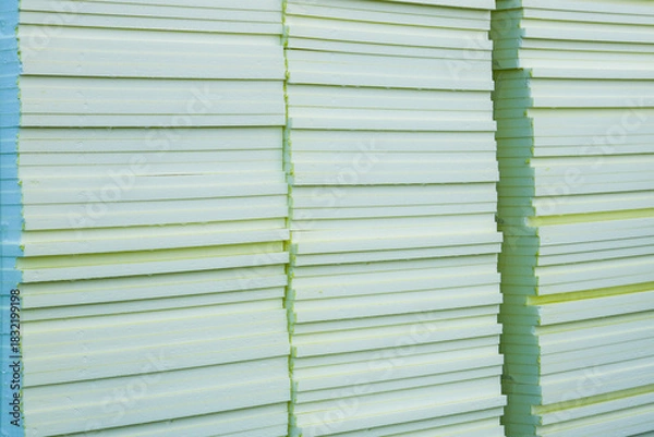 Fototapeta Stacked insulation foam boards at construction site ready for building thermal insulation work
