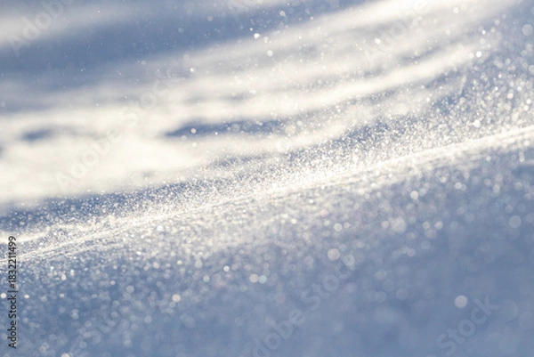 Fototapeta Surface of glittering snow with blizzard on cold and sunny winter day in Finnish nature, Europe