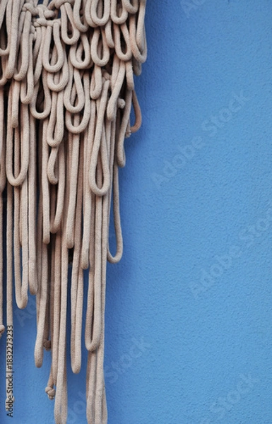 Obraz Beige Macramé Wall Hanging Against Blue Background