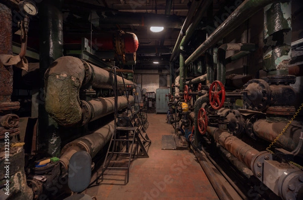 Fototapeta Old vintage control center in the boiler room with tubes and round water taps