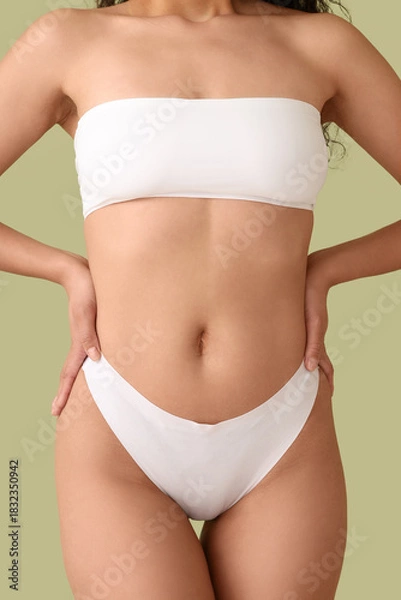 Fototapeta Beautiful young African-American woman with stretch marks on her body against green background, closeup