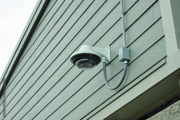 Fototapeta CCTV camera installed on the wall of a building.