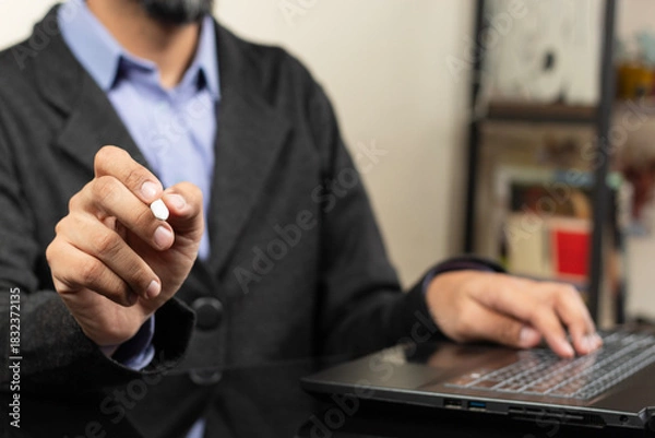 Fototapeta a modern business man pointing with his right hand with a white digital pen to something in the space