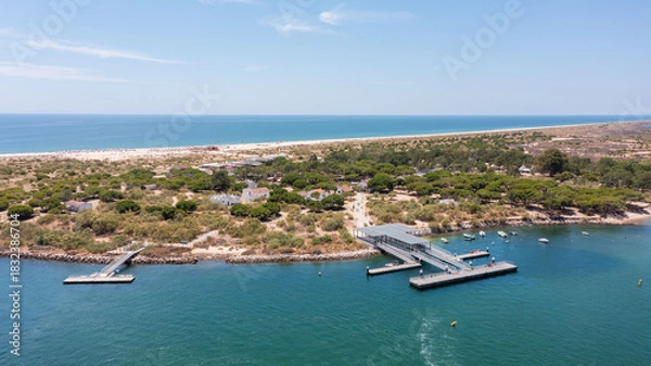 Fototapeta Aerial view of serene coastal landscape featuring calm waters, sandy beaches, and lush greenery, perfect for relaxation and nature exploration. Tavira Portugal Algarve