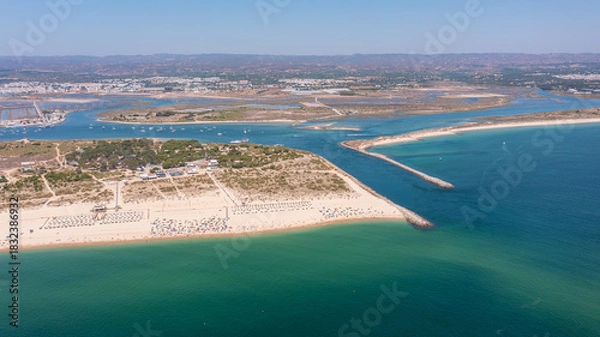Fototapeta Aerial view of serene beach landscape with golden sands and turquoise waters, showcasing natural beauty and tranquility in coastal environment. Tavira Portugal Algarve