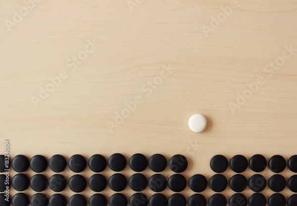 Obraz be different concept with go stones background