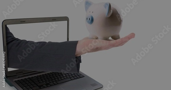Obraz Extending suited arm from laptop screen, holding ceramic piggy bank with blue accents, copy space