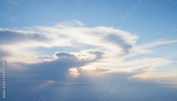 Fototapeta Soft blue sky background with layered clouds and sunlight rays creating serene atmosphere and subtle pastel tones Background Concept