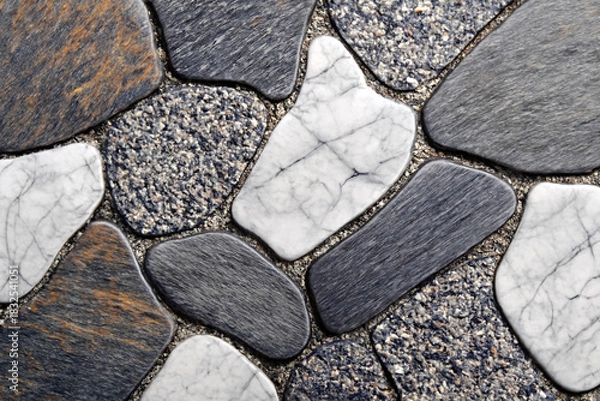Fototapeta Natural stone floor texture background with polished irregular pebbles in a mosaic pattern. Grey, white, and marble details on a decorative pavement surface for architectural design.