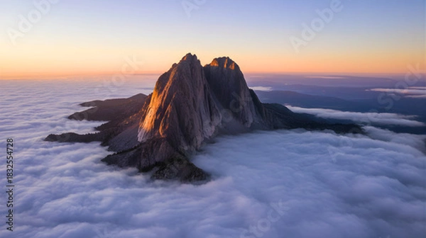 Obraz Dramatic Sunrise Over Mountain Peak Emerging from a Sea of Clouds
