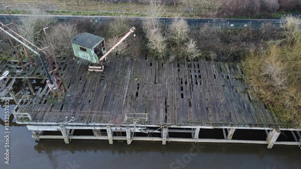Fototapeta Aerial view of an abandoned crane on a derelict wooden dock