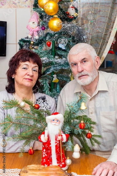 Fototapeta beautiful elderly couple holding big clock on new years eve