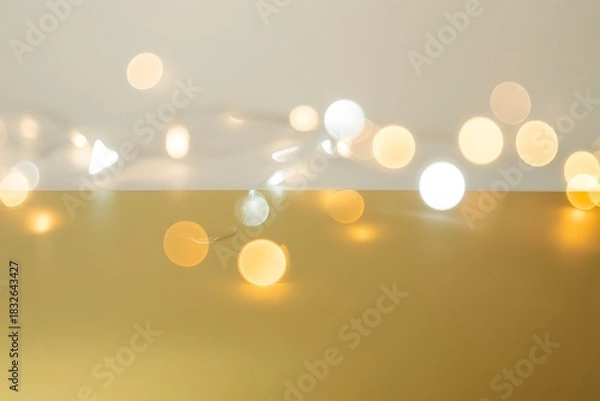 Fototapeta Warm glowing string lights create a festive and elegant ambiance on gold background perfect for holiday promotions and seasonal designs adding a touch of magic