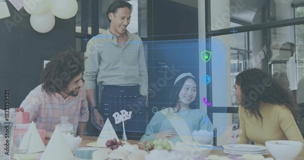 Fototapeta Laughing team leaning toward office table, celebrating guest wearing sash, headband with hologram