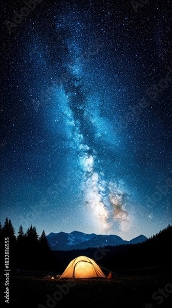 Obraz A glowing tent is set up under a stunning night sky filled with the Milky Way galaxy. The scene is illuminated by the tent's warm light.