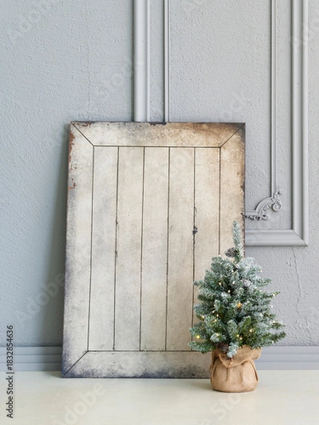 Obraz Cozy Christmas interior scene with decorated mini tree, ornaments, gifts, nutcrackers, modern chair, and elegant textured wall background.