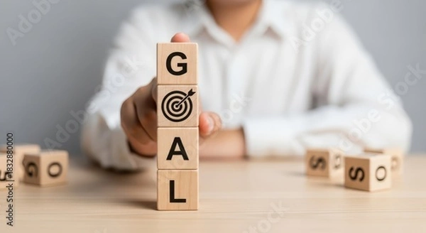 Obraz Setting Business Goals and Achieving Success Concept with Hand Stacking Wooden Blocks Labeled 'GOAL' and Target Icon