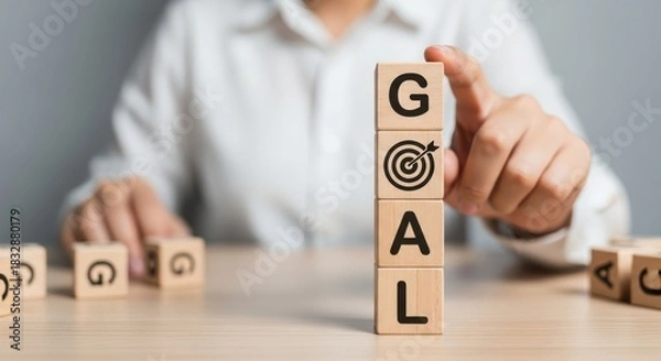 Obraz Setting Business Goals and Achieving Success Concept with Hand Stacking Wooden Blocks Labeled 'GOAL' and Target Icon