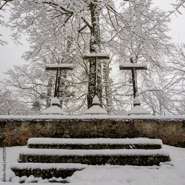 Fototapeta Faith enduring : three crosses covered by silent winter snow.