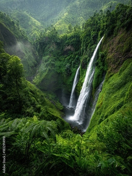 Obraz Majestic Twin Waterfalls Cascading Through Lush Green Tropical Forest.